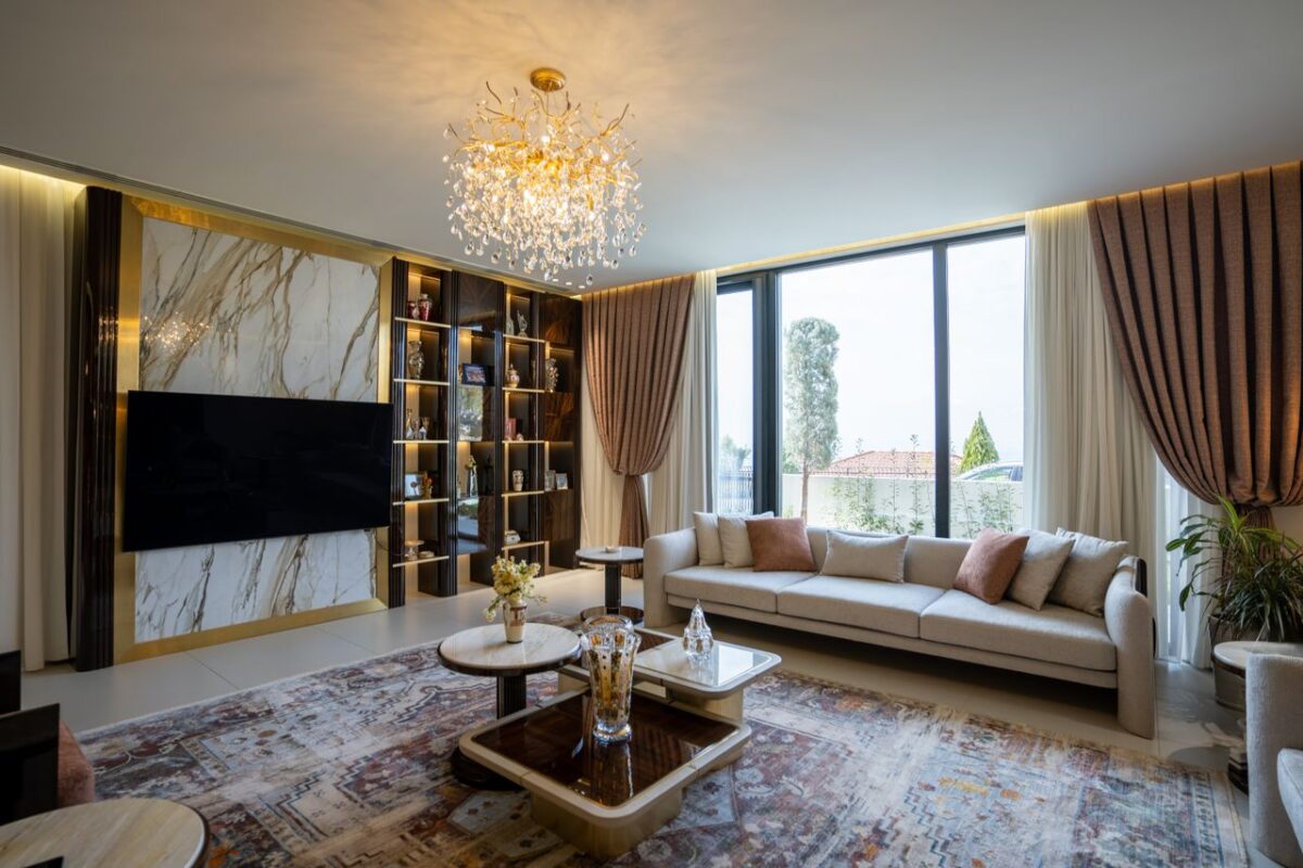 Services Luxurious modern living room with chandelier and large windows in Sulaymaniyah, Kurdistan.